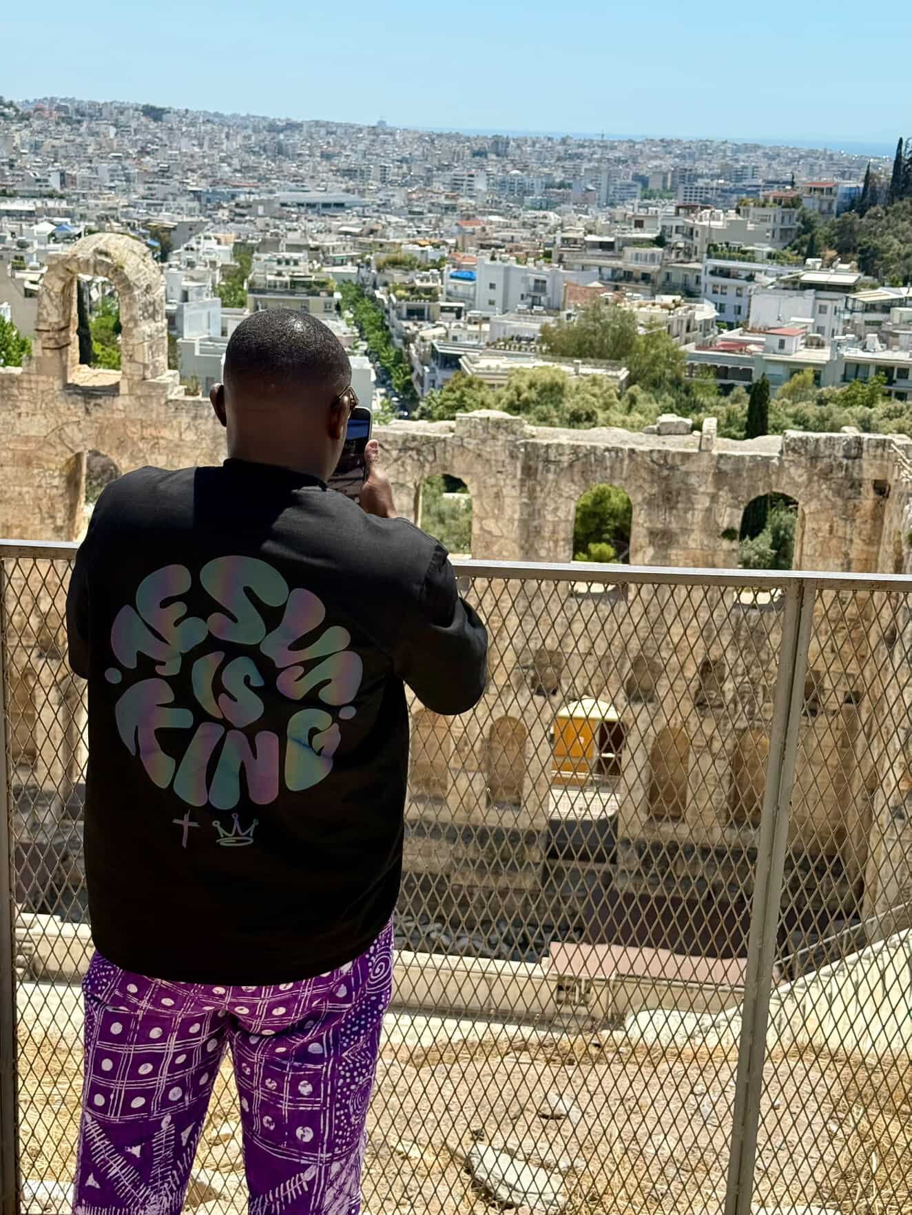 Person taking a photo of a cityscape from an elevated viewpoint. #PhocusbyTimmy